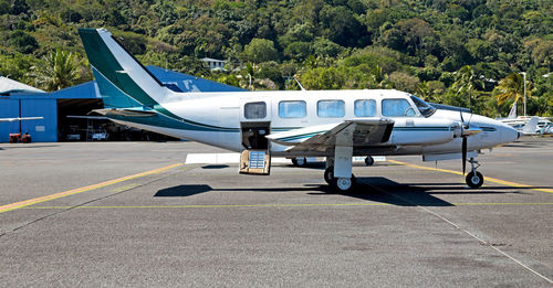 Side view of airplane on airport runway