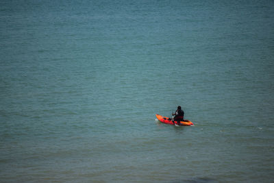 Man sitting in boat on sea