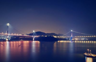 Illuminated bridge over river