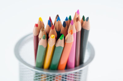 Close-up of colored pencils against white background