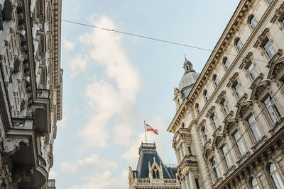 Low angle view of building against cloudy sky