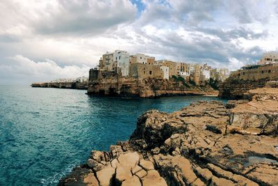 Panoramic view of sea and buildings against sky