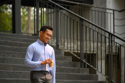 Portrait of young man standing in building