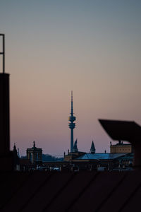 Silhouette buildings against sky during sunset