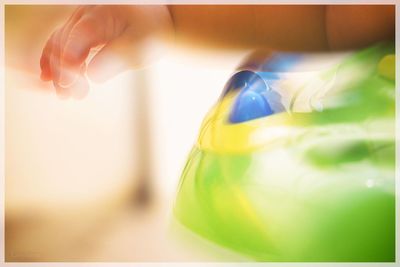 Close-up of hand holding bottle