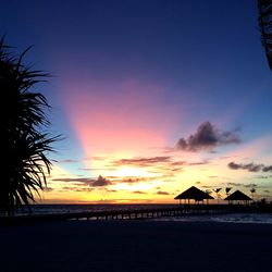 Scenic view of beach against sky during sunset