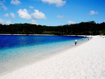 Scenic view of beach against cloudy sky