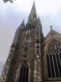 Low angle view of bell tower against sky