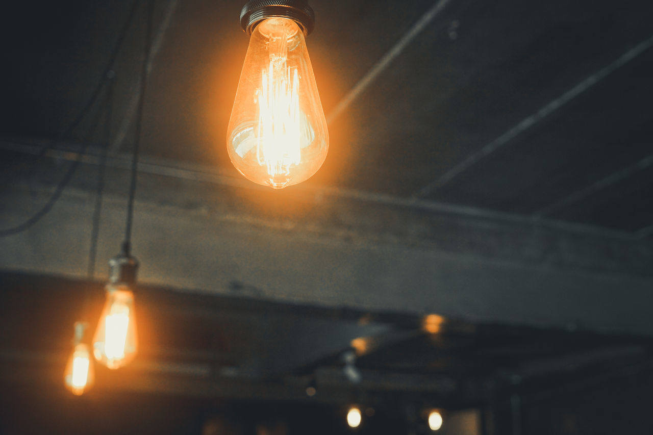 LOW ANGLE VIEW OF ILLUMINATED LIGHT BULBS