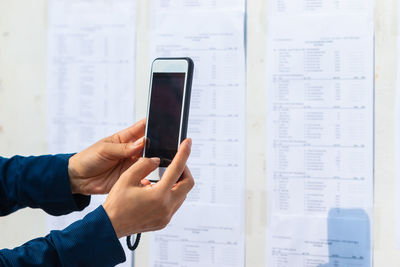 Midsection of man using mobile phone