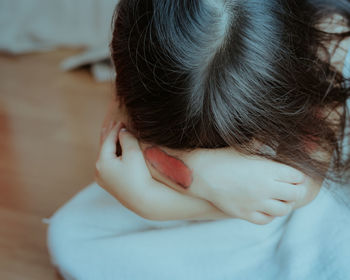 Close-up of girl crying at home