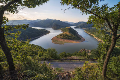 Scenic view of lake and mountains against sky