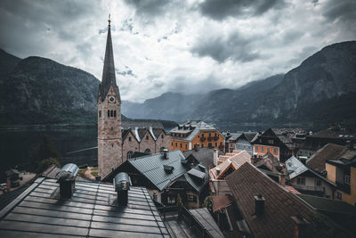 Panoramic view of buildings and mountains against sky