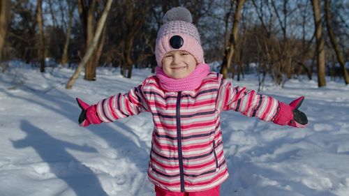Child standing outdoors during winter