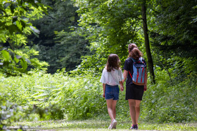 Rear view of woman walking on field