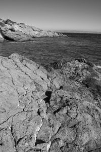 Scenic view of rocks on beach against sky