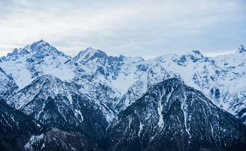 Scenic view of snowcapped mountains against sky