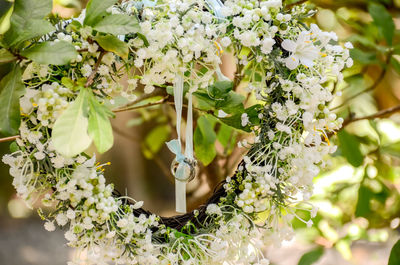 White flower wreath with wedding ring