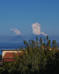 Scenic view of sea and buildings against sky