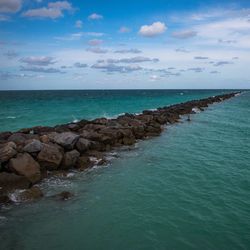 Scenic view of sea against cloudy sky