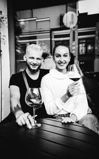 Portrait of a smiling young man and woman in restaurant