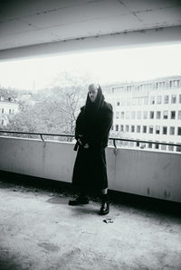 Full length rear view of woman standing in winter