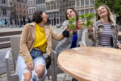 Friends sitting on street