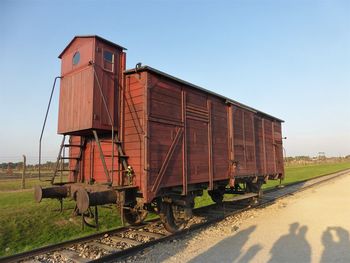 Train on railroad track against clear sky