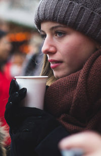 Close-up of woman drinking coffee at home