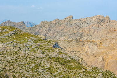 Low angle view of rocks on mountain against sky