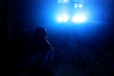 Man in illuminated room