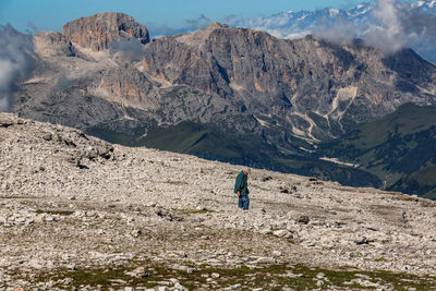 Rear view of man walking on mountain