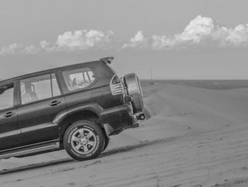 Cars on road against sky