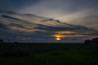 Scenic view of field against sky during sunset