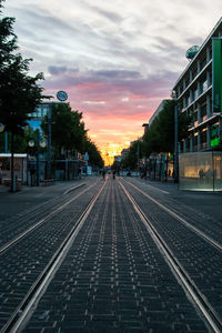 Railroad tracks against sky during sunset