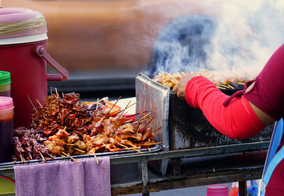 Person holding meat at market stall