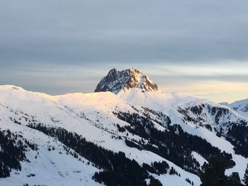 Scenic view of snow covered mountains against sky