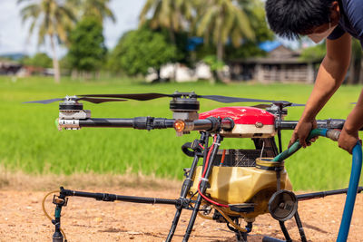 Agriculture drones fly over rice fields sprinkling fertilizer