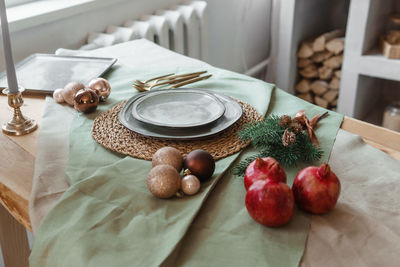 Serving a festive christmas table in scandinavian style. decor on the table before the holiday