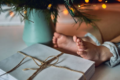 Close-up of woman with tattoo on table at home