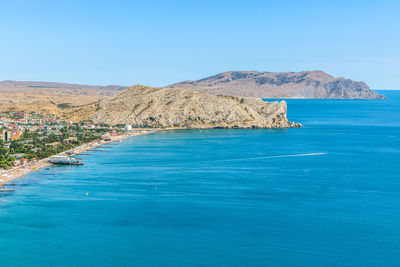 Scenic view of sea against clear blue sky