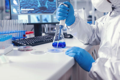 Midsection of scientist working in laboratory