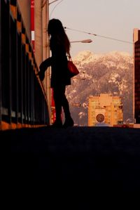 Full length of woman standing on bench