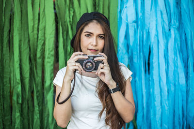 Portrait of smiling woman photographing