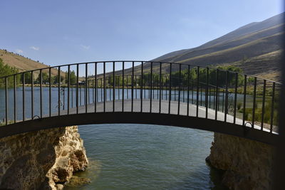 Bridge over river against sky