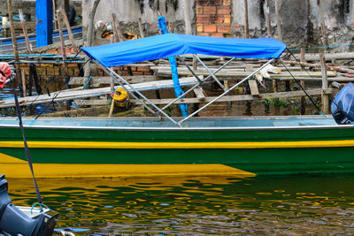 Boats moored in river against blue sky