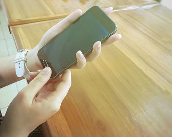 High angle view of person hand on table