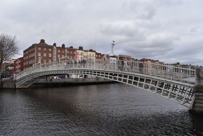 View of bridge over river against cloudy sky