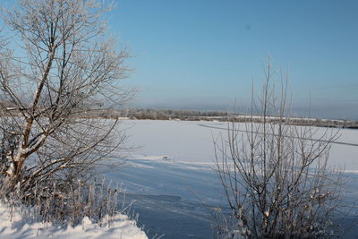 Scenic view of snow covered field against sky