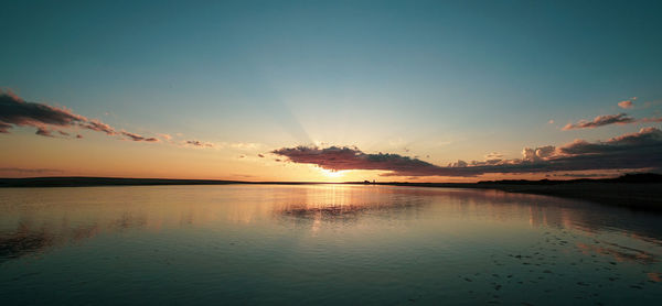 Scenic view of lake against sky during sunset